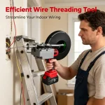 Electrician using a conduit cable puller to thread wires through a curved residential pipe during indoor renovation